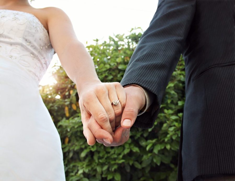 bride and groom holding hands