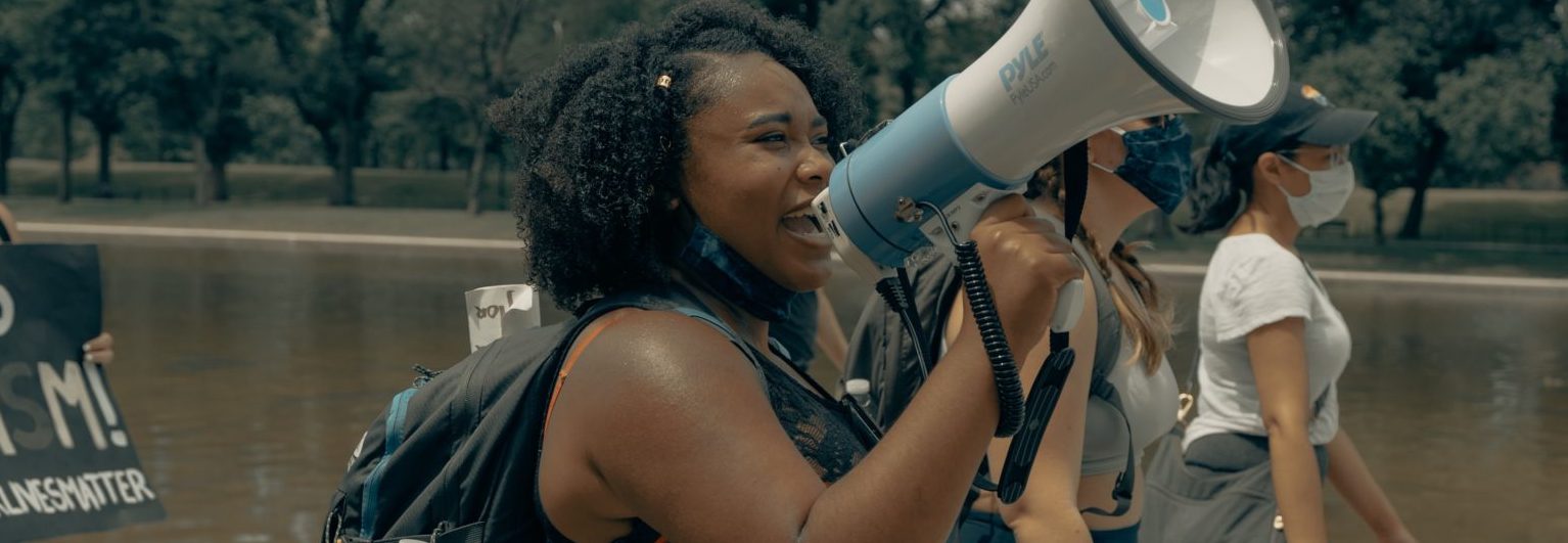 BIPOC protestor with megaphone